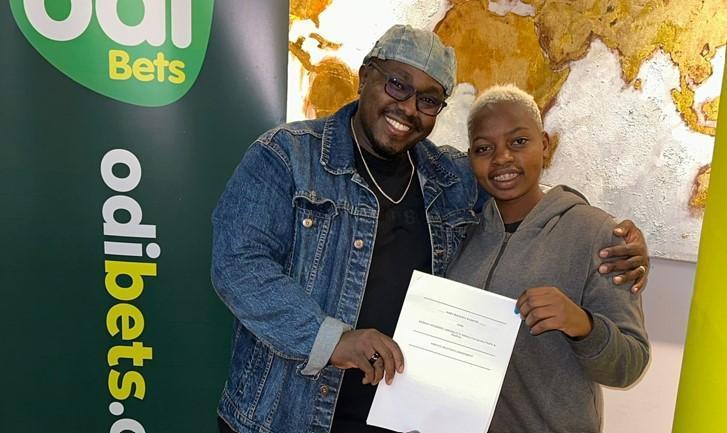 File Image of Kaveve Kazoze Hitmaker ‘Ngesh’ with Odibets General Manager Dedan Mungai.